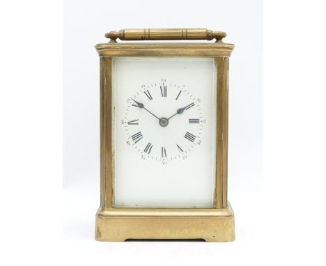 A 20th century brass striking carriage clock, white enamel dial with Roman numerals, the movement striking the half and hours