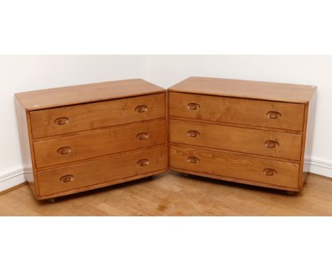 A pair of 1960s Ercol 'Windsor' low chest of drawers, model 412 in light elm, having three long drawers with turned button ha