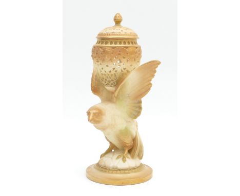 A Royal Worcester reticulated pot pourri jar with lid, decorated in blush ivory with gilt highlighting and a bird support.