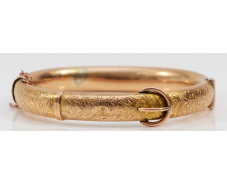 An Edwardian 9ct rose gold hinged buckle bangle, Chester 1907, the front with engraved scroll decoration, 60 x 49mm, 9mm wide