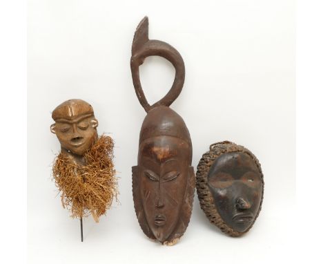 Ethnographica &amp; Tribal Art: A group of three African tribal  masks, carved wood, coconut husk fibre ruff with incised dec