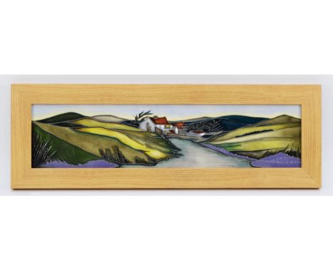 A Moorcroft plaque, depicting house nestled amongst green hills, with a river in the foreground, designed by Emma Bossons, da