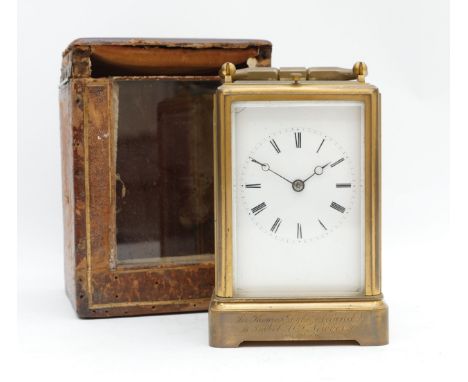 A late 19th century brass repeating and striking carriage clock, white enamel dial with Roman numerals, unusual full glass to