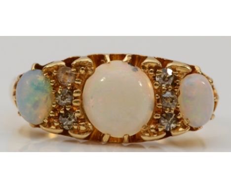 A Victorian 18ct gold opal three stone ring, with rose cut diamonds between, M, 4.3gm