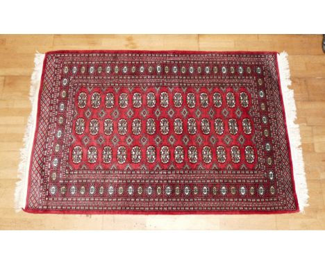 A Teke Turkmen Bokhara Deluxe rug, with a fringe trim, the Teke design is inspired by elephant footprints, 188cm x 127, in re