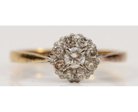 An 18ct gold and platinum brilliant cut diamond floral cluster ring, approx 0.15ct central diamond surrounded by eight approx