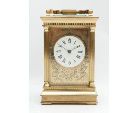 A 20th century brass striking carriage clock, white enamel dial with Roman numerals and floral engraved surround, the 11 jewe