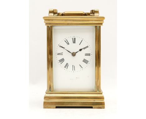 A 20th century brass striking carriage clock, white enamel dial with Roman numerals, the movement striking the half and hours