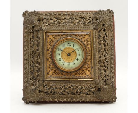 The British United Clock Co., Ltd., a late 19th pierced cast brass desk clock, with easel back, 16 x 16cm.Movement ticks but 