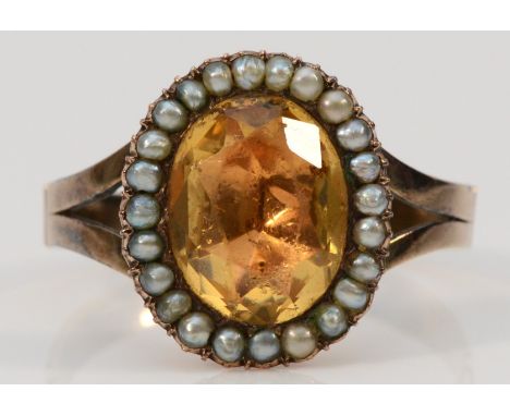 A 9ct gold paste and seed pearl oval cluster ring, central paste measures 12mm x 9mm, O 1/2, 3.3g