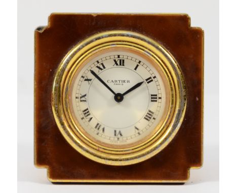 Cartier, a gold plated and brown lacquer manual wind alarm clock, model 7512, serial number 03003, synthetic sapphire crown, 