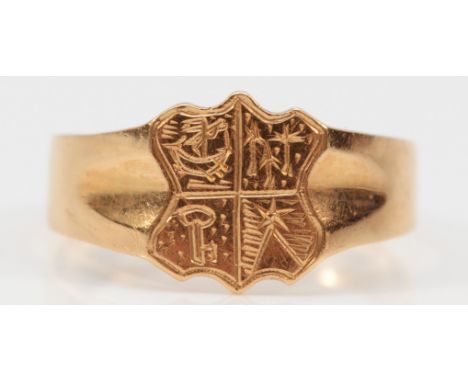 An unhallmarked15ct gold antique crest signet ring, crest has small engravings of a ship, a key, trees and a pyramid, N 1/2, 