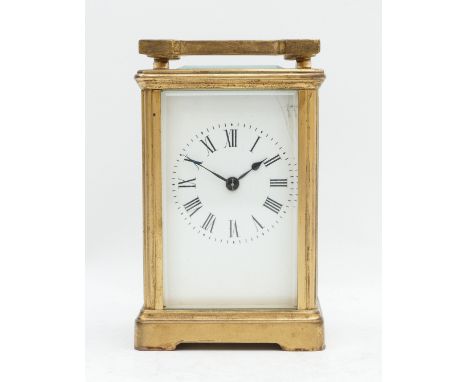 An early 20th century brass striking carriage clock, white enamel dial with Roman numerals, the movement striking the half an