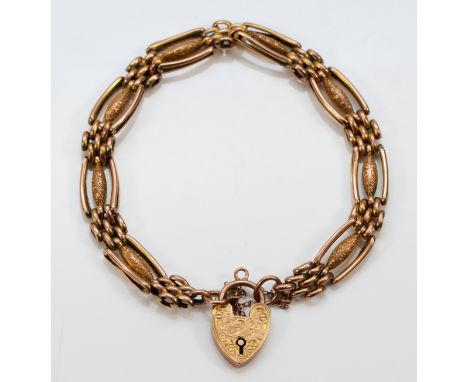 An Edwardian 9ct rose gold Night and Day gate bracelet, with engraved heart padlock, 19cm, 12.3gm