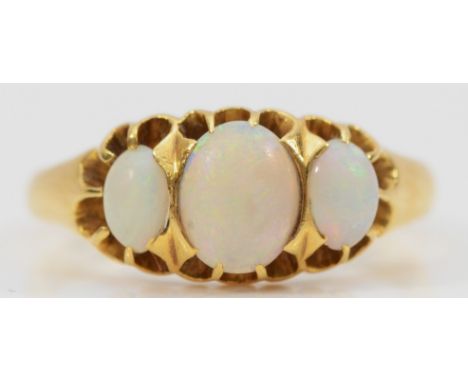 An 18ct gold opal three stone ring, Birmingham 1910, central opal measures 7mm x 5mm, 3.2g