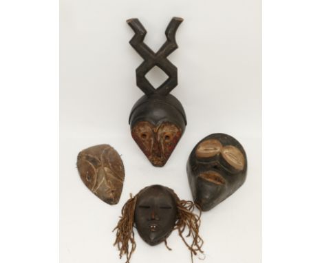 Ethnographica &amp; Tribal Art: A group of four African, Dan, Ivory Coast, tribal masks, carved wood with incised decoration 