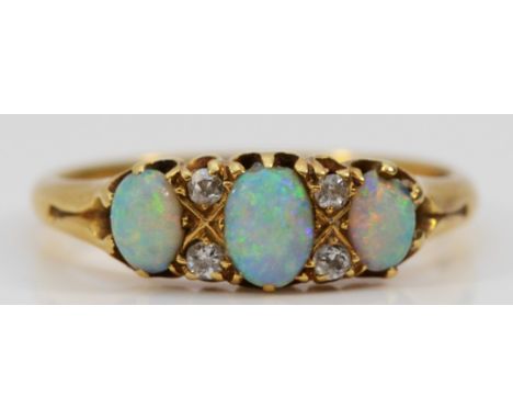 An Edwardian 18ct gold opal and old cut brilliant diamond three stone ring, Q, 3.4gmGood colour opals, one side opal has a sm