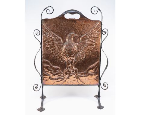 An Arts and Crafts hand beaten copper fire screen, c. 1910/20, depicting an eagle with outstretched wings, mounted in an wrou