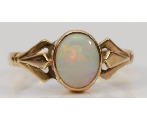 A 9ct gold opal dress ring, London 1982, 9mm x 7mm opal, decorative split shoulders, V 1/2, 3.7g