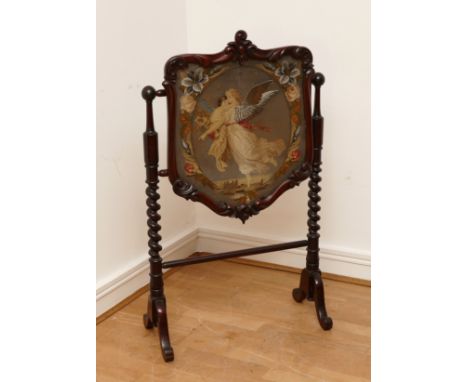 A Victorian mahogany fire screen, scrolled foliage carved pediment, shield frame enclosing figural needlework tapestry panel,