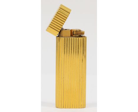 Cartier, Paris, a gold plated oval rollagas ribbed lighter, signed, numbered 27200 S