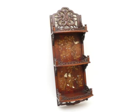 A 20th century Chinese three height wall shelf, the carved galleried top above three curved shelves, having finely carved fre