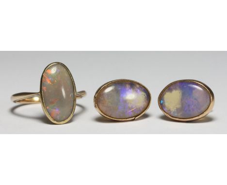 A 9ct gold ring set with a solitaire oval opal, together with a pair of yellow metal (test as 9ct gold) opal earrings. Gross 