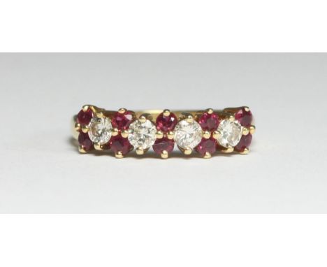 An 18ct gold ring, the top set with four RBC diamonds and ten small ruby coloured stones, estimated total diamond weight appr