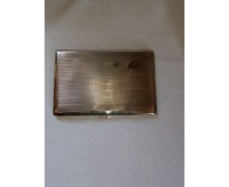 A silver Art Deco style cigarette case, the exterior with engine turned decoration, opening to reveal a gilt interior, hallma