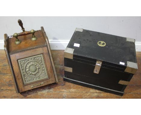 A small black painted pine trunk with metal strap work and applied brass naval crest to top and a walnut coal scuttle with br