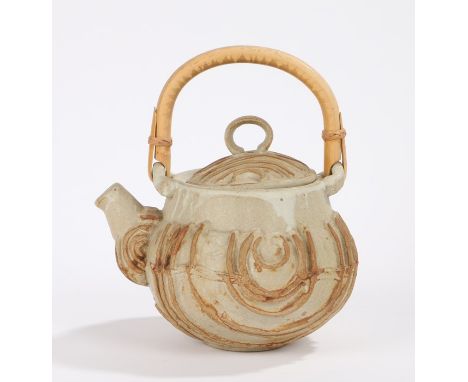 Bernard Rooke pottery teapot, with bamboo handle, the body with raised curving line decoration, 24cm high to top of handle