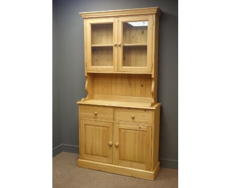 Solid pine dresser, projecting cornice, two glazed cupboards doors enclosing two shelf, above two drawers and two cupboard do