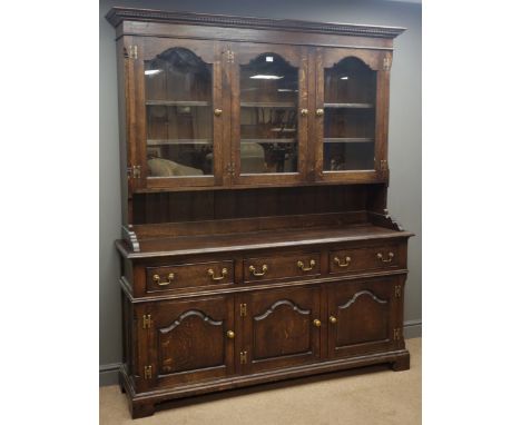 Traditional oak dresser, projecting cornice, three stepped arched glazed doors enclosing three shelves, above three drawers a