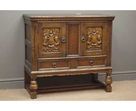 18th century style carved cupboard, two doors with coat of arms carvings above two drawers, reeded and fluted uprights, turne