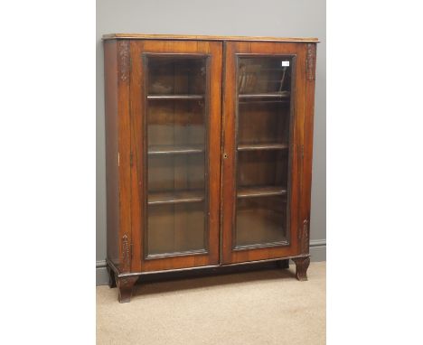 Early 20th century mahogany bookcase, acanthus carved sides, two glazed doors, four shelves, shaped bracket supports, W100cm,