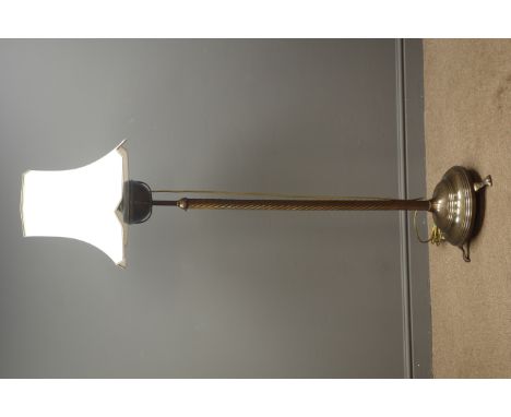 Late 19th century bronzed converted standard lamp with oil reservoir, twist column on circular platform base with three scrol