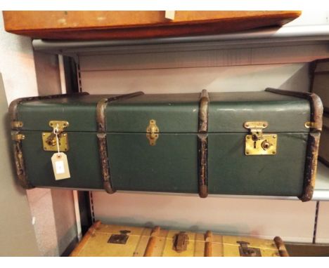 A mid-20thC green wooden bound shipping trunk with leather handles 