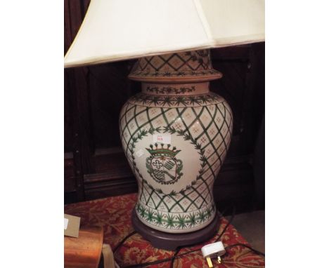 An armorial green and white lidded ginger jar lamp