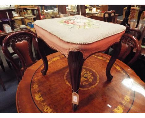 A late 19thC mahogany stool with tapestry upholstered seat and raised on carved cabriole shaped supports