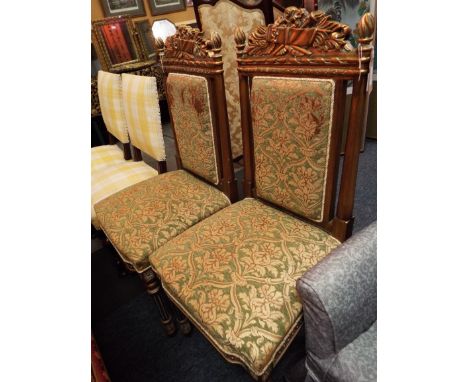 A pair of French gilt side chairs with floral carved top rails above padded backs and over stuffed tapestry style seats raise