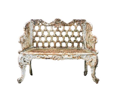 A VICTORIAN HEAVY CAST IRON GARDEN BENCH. the bench with arched decorated back with scrolling arms over a pierced seat, suppo