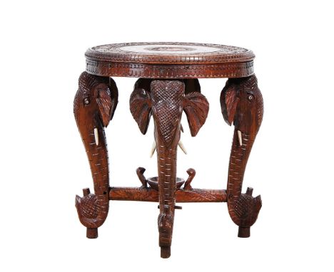 A LATE 19TH CENTURY INDIAN CARVED HARDWOOD ELEPHANT OCCASIONAL TABLE. circular top with blind fretwork border and circular ba