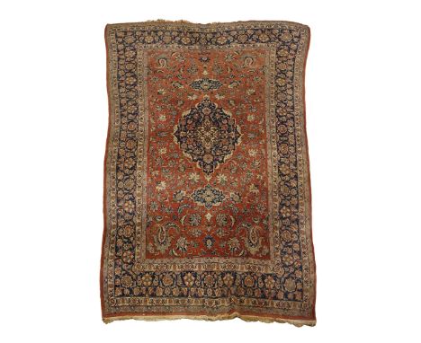 A PERSIAN TABRIZ CARPET. reg ground with a large central medallion, 320cm x 205cm.  *Condition:  General wear, marks and fadi