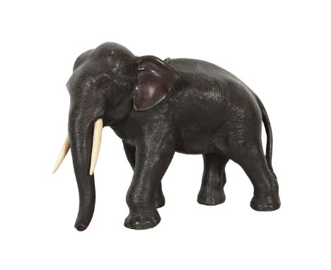 A JAPANESE BRONZE ELEPHANT, MEIJI PERIOD. With Ivory tusks and cylindrical container insert , signed to base Seiya Genryusai,