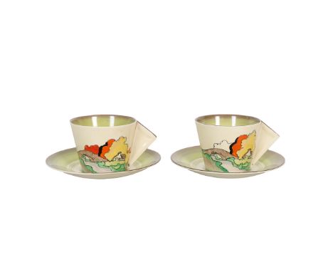 A PAIR OF UNUSUAL CLARICE CLIFF 'LORNA' PATTERN CUP AND SAUCERS. both cups hand painted with a river side cottage landscape w