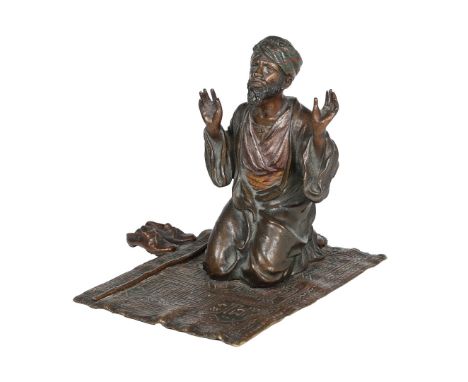 FRANZ BERGMAN, AUSTRIAN (1861-1936) A COLD PAINTED BRONZE MODEL OF AN ARAB AT PRAYER. kneeling on a prayer rug, his shoes and