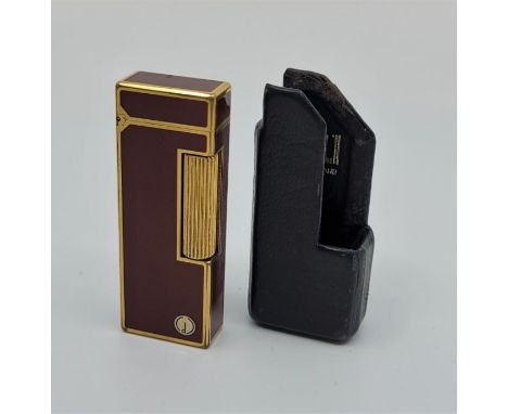 A Dunhill rollagas cigarette lighter, with Dunhill outer sleeve.&nbsp;