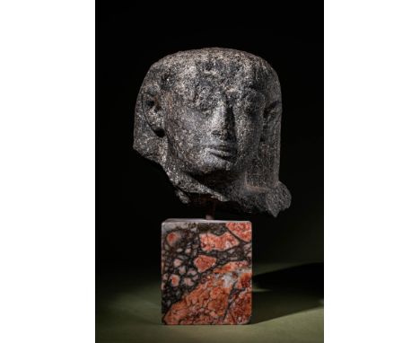 New Kingdom, 19th Dynasty, Ca. 1307 - 1196 BC.A black stone head of a pharaoh. The figure wears a headdress with visible deta