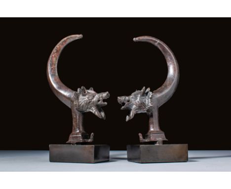 Ca. AD 100 - 300.A matched pair of chariot fittings, each formed as the head and forelegs of a boar with open mouth and promi