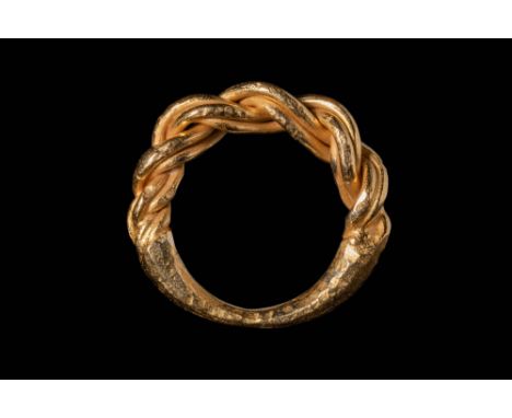 Ca. AD 800 - 1100.A gold wearable ring formed from twisted wires. The middle of the shank features thick wires coiled around 